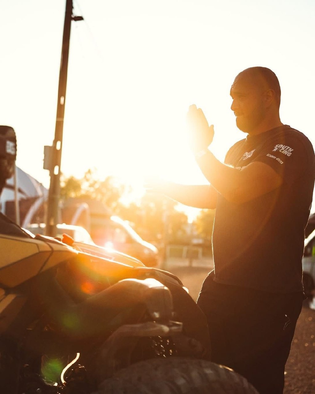 Warren Naude checking a rally-raid vehicle in the evening light
