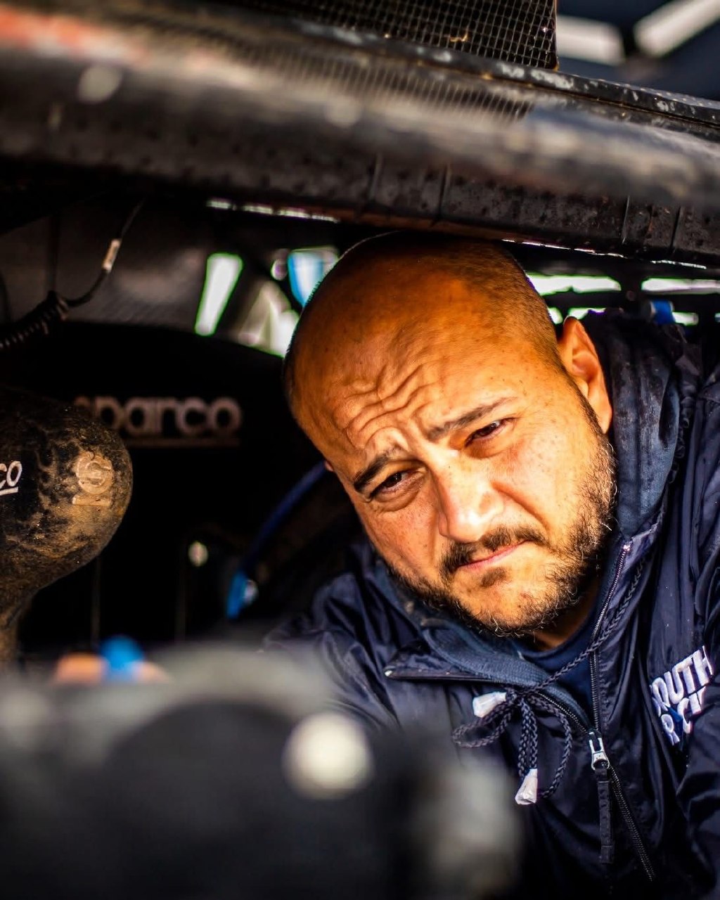 Warren Naude inspecting a rally-raid vehicle