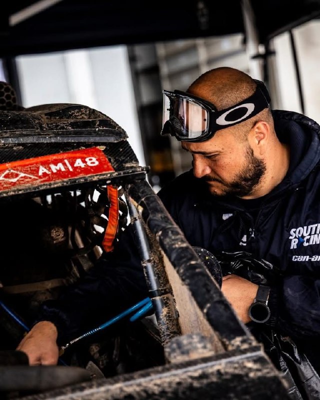 Warren Naude working on a rally-raid vehicle in the service area