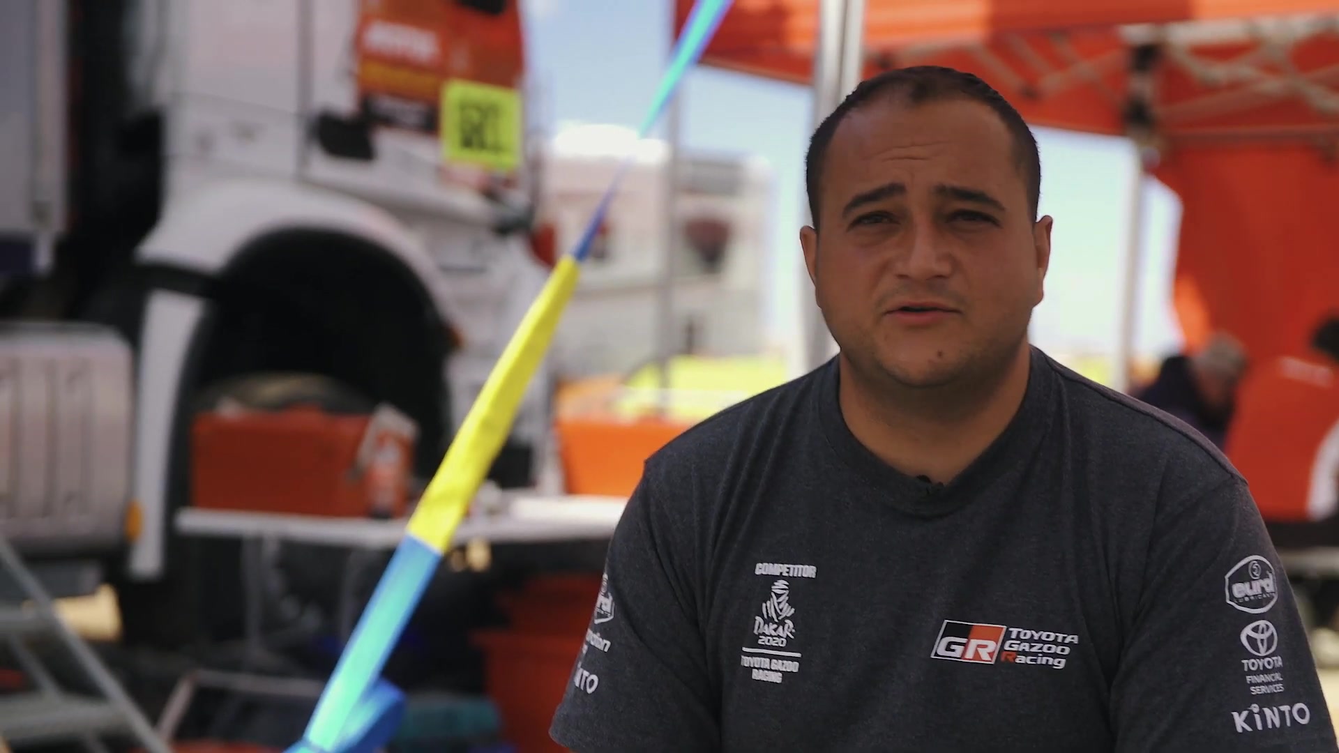 Warren Naudé speaking to camera in the Toyota Gazoo Racing Dakar service park